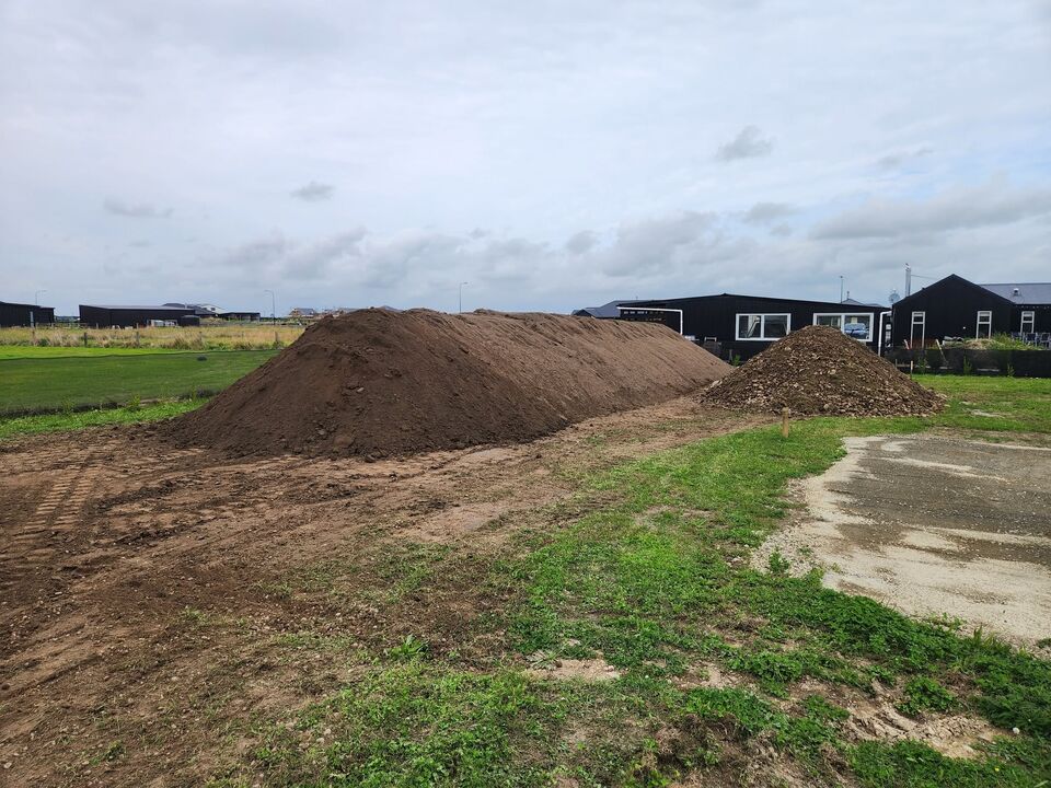 Finished screened soil produced by tracked trommel screening