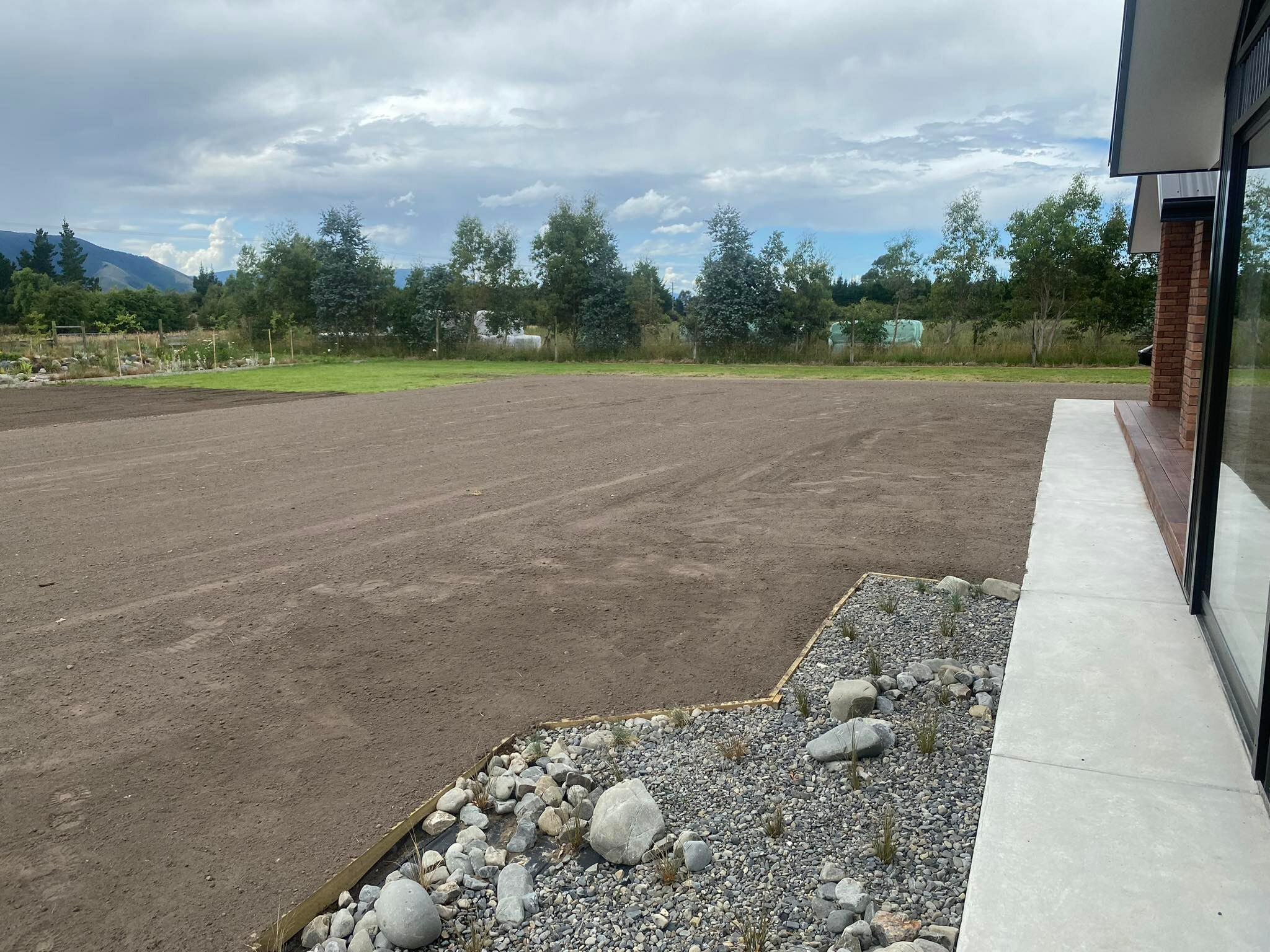 Topsoil spread and graded around a Christchurch new build